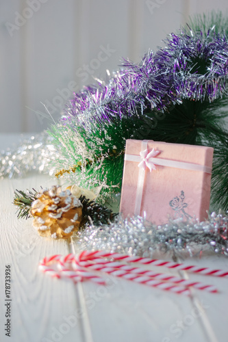 Box with new year gifts and presents on white wooden board.
