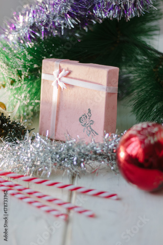Box with new year gifts and presents on white wooden board.