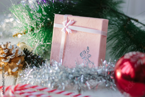 Box with new year gifts and presents on white wooden board.