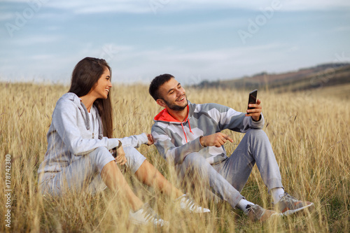 Young couple doing a selfie after jogging in nature