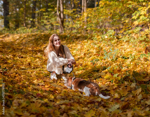 Beautiful girl with dog in the park.