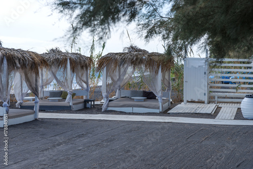 Relaxation zone on the black beach between the villages of Perissa and Perivolos in Santorini