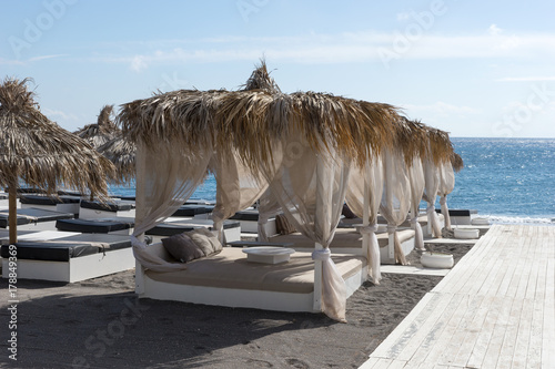 Relaxation zone on the black beach between the villages of Perissa and Perivolos in Santorini