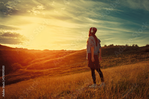 Young woman enjoys the sunset in nature