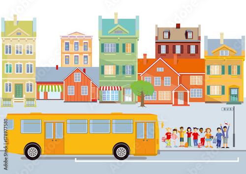 Vergnügte Schulkinder vor dem Schulbus