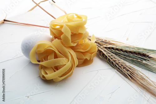 traditional italian homemade pasta with ingredients on white background.