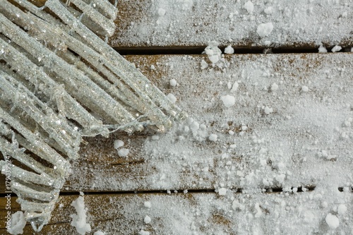 Cropped image of star shape decoration amidst artificial snow