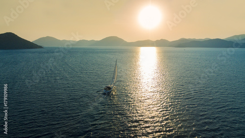 Boat sailing into the sun in Mediterranean Sea