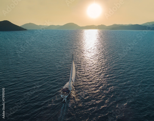 Boat sailing into the sun in Mediterranean Sea