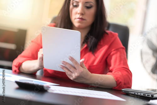 Young attractive businesswoman using a tablet, light effect