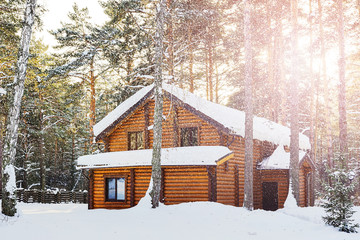 A wooden house in a winter forest