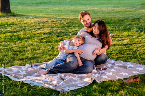Happy pregnant family of three expecting new baby