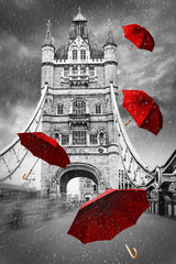 Tower Bridge on River Thames with flying umbrellas. London, England. Black and white concept graphic with red element.
