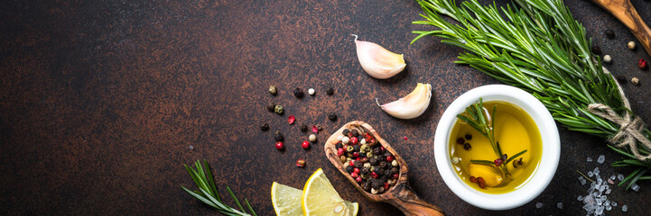 Selection of spices and herbs on dark rusty table.