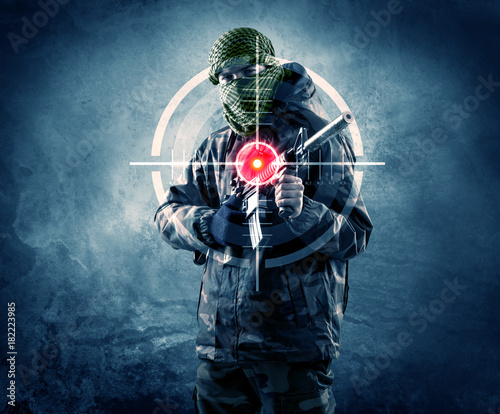 Fotoobraz na płótnie Zamaskowany terrorysta z pistoletem i celownikiem laserowym na swoim ciele