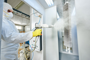 industrial metal coating. Man in protective suit, wearing a gas