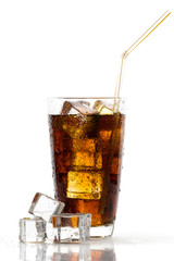 Glass of cola with ice cubes and straw on white background