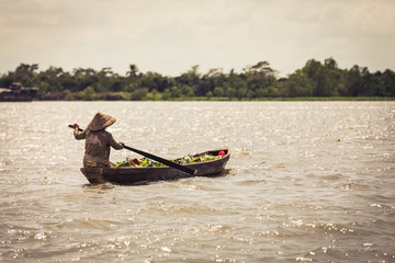 Woman rowing a wooden boat