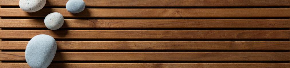 zen pebbles set on design wooden board, top view banner