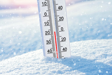 Wintertime. Winter background with  thermometer in the snow on frosty day.