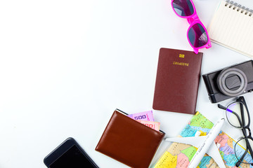Travel accessories costumes concept for summer vacation trip. Passports, luggage, map, smartphone,sun glasses,camera, note pad, jean on white