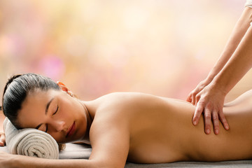 Side view of woman having hot oil massage is spa.