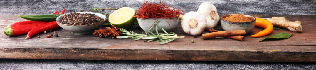 Spices and herbs on grey background. Food and cuisine ingredients.