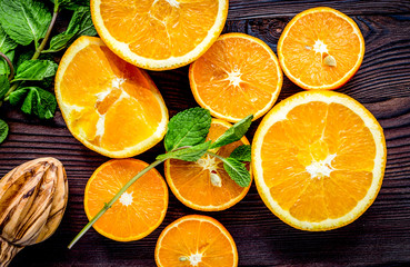 orange juice with mint squeezing on wooden kitchen background to