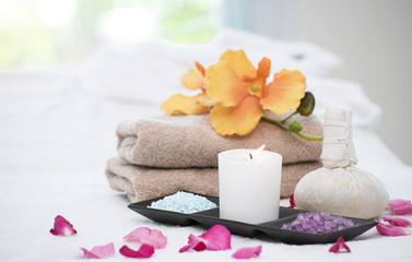 Spa accessories still life with aromatic candle,orchid flower, salt and towel.