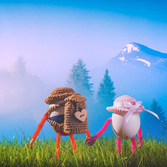Two Easter eggs hikers in a hats with backpacks