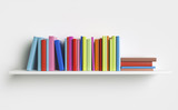 Multicolored books on a shelf