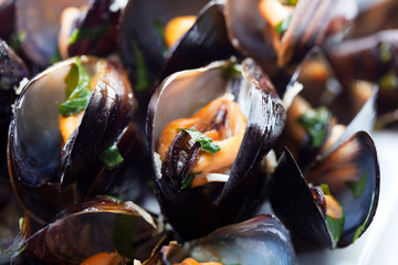 Black mussels on plate with green