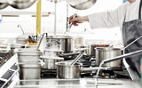 Chef in hotel or restaurant kitchen cooking