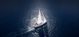 Amazing view to Yacht sailing in open sea at windy day. Drone view - birds eye angle.