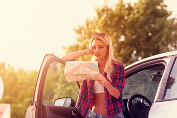 Beautiful young woman traveler lost on highway