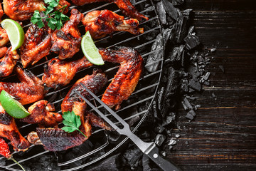 chicken wings of barbecue in honey sauce with lime slices. the dish is made and served in a rustic style