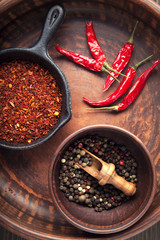 Selection of spices pepper. Food background on black wood table. Top view