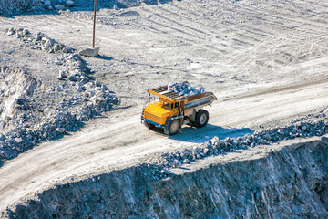 Quarry dump truck loaded with stones