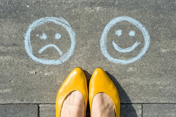 Choice - Happy Smileys or Unhappy, text on asphalt road