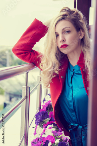 Фото: Outdoor fashion portrait of glamour young cheerful stylish lady wearing trendy red coat. Blonde long hair. Full lips, green eyes. Outdoor fashion portrait of glamour young cheerful stylish lady wearing trendy red coat. Blonde long hair. Full lips, green eyes.