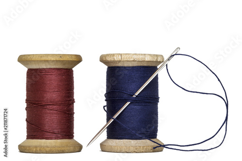 Фото: sewing threads spools with sewing needle,isolated on white background sewing threads spools with sewing needle,isolated on white background