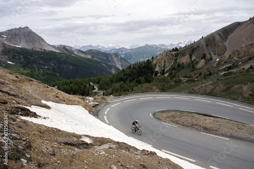 Фото: lonely man on bicycle almost at the top of col d'izoard in the alps of french haute provence lonely man on bicycle almost at the top of col d'izoard in the alps of french haute provence