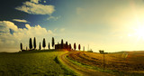 typical Tuscany countryside landscape; sunset over rolling hills and Tuscany village