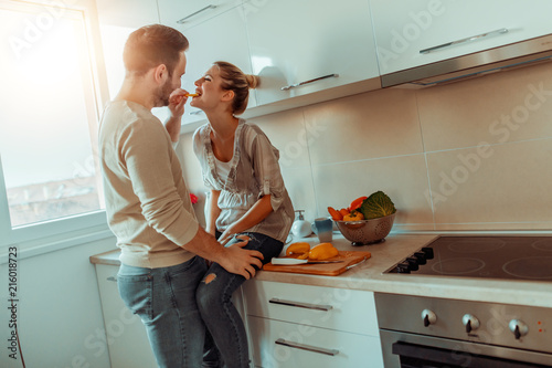 Romantic young couple cooking together in the kitchen Romantic young couple cooking together in the kitchen