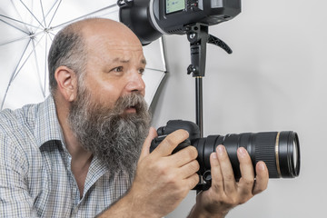 bearded senior photographer at work