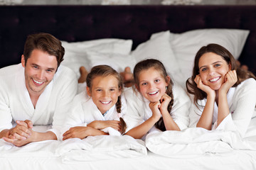 Happy family relaxing in hotel room