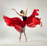 Ballerina. Young graceful woman ballet dancer, dressed in professional outfit, shoes and red weightless skirt is demonstrating dancing skill.
Beauty of classic ballet dance.