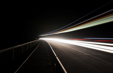 Beautiful abstract lights in a car tunnel in white, green, purple