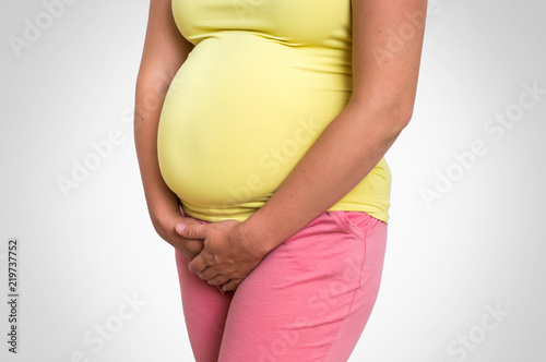 Foto obraz na płótnie canvas czteroczęściowy - "tetraptyk" - Pregnant woman with frequent urination problem
