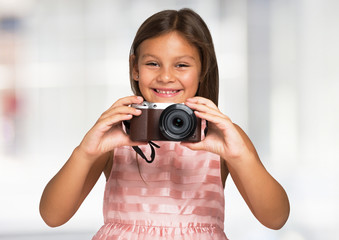Smiling child holding a camera